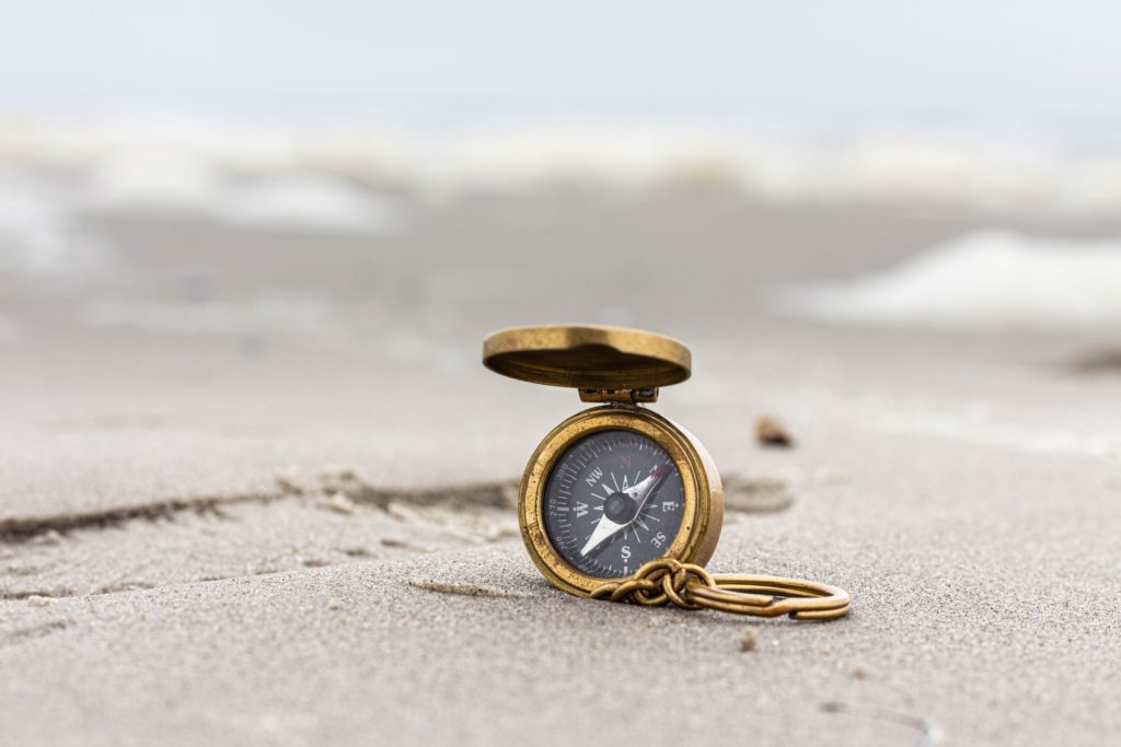 gold pocket watch on beach